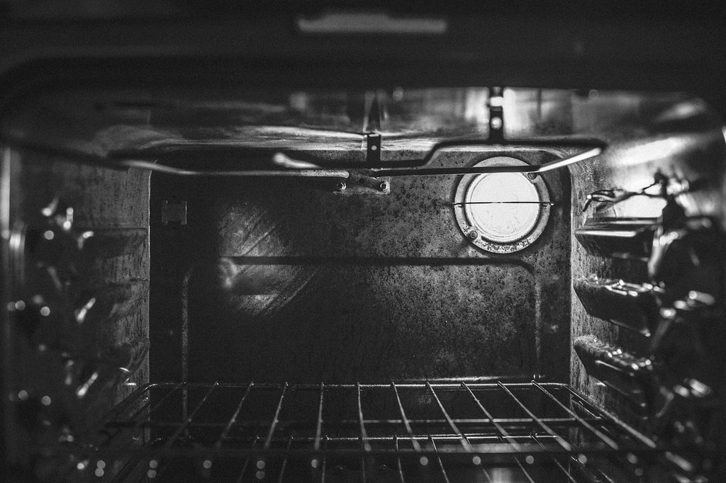 inside of a black oven with oven racks