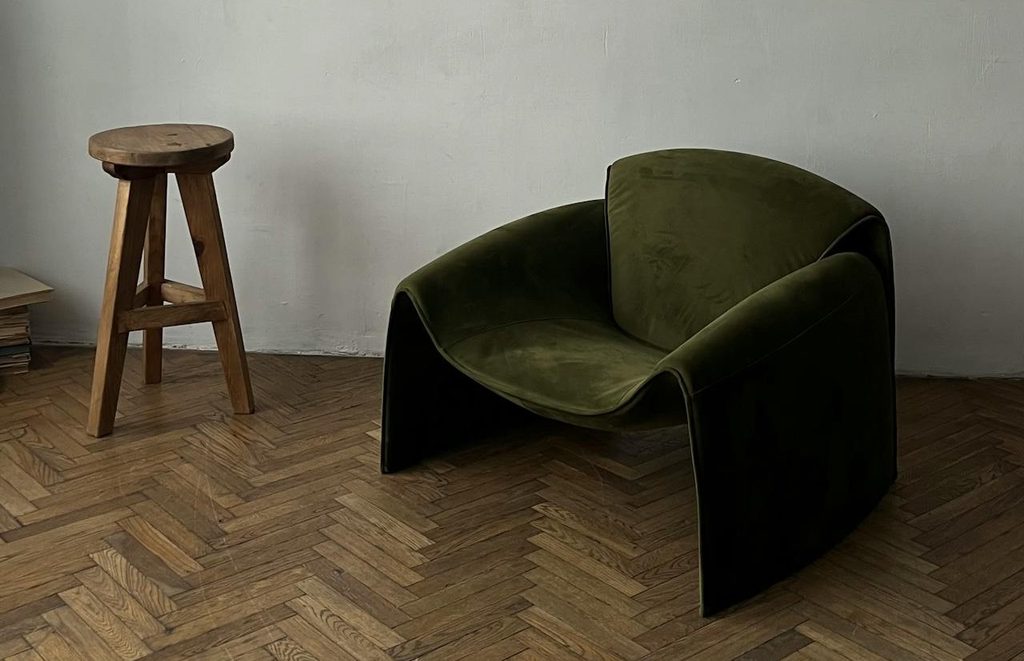 modern green chair and stool on classic parquet flooring