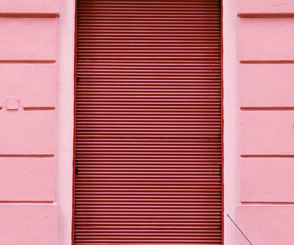 pink siding around a window with pink blinds