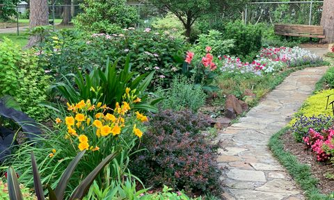 Stone pathway through a flower garden