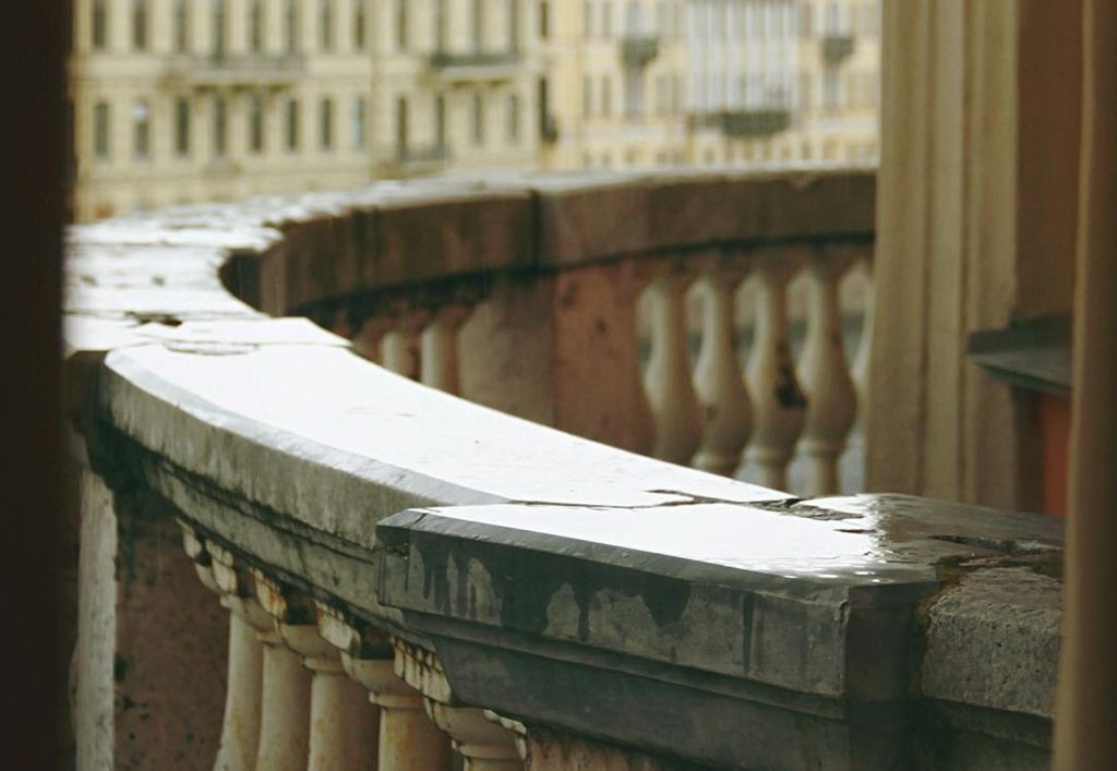 curved stone railing on city balcony