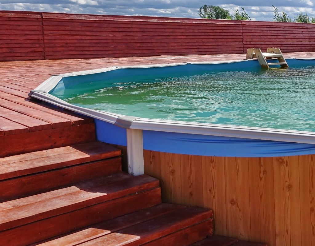 Above-ground pool with deck and stairs