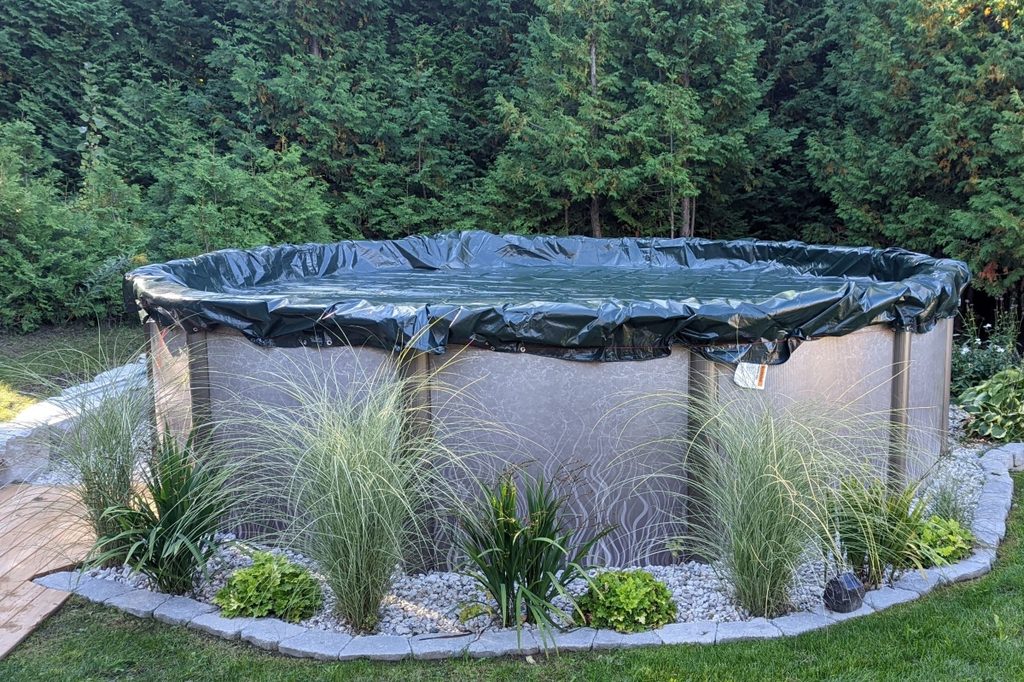 above-ground pool with partial deck and landscaping