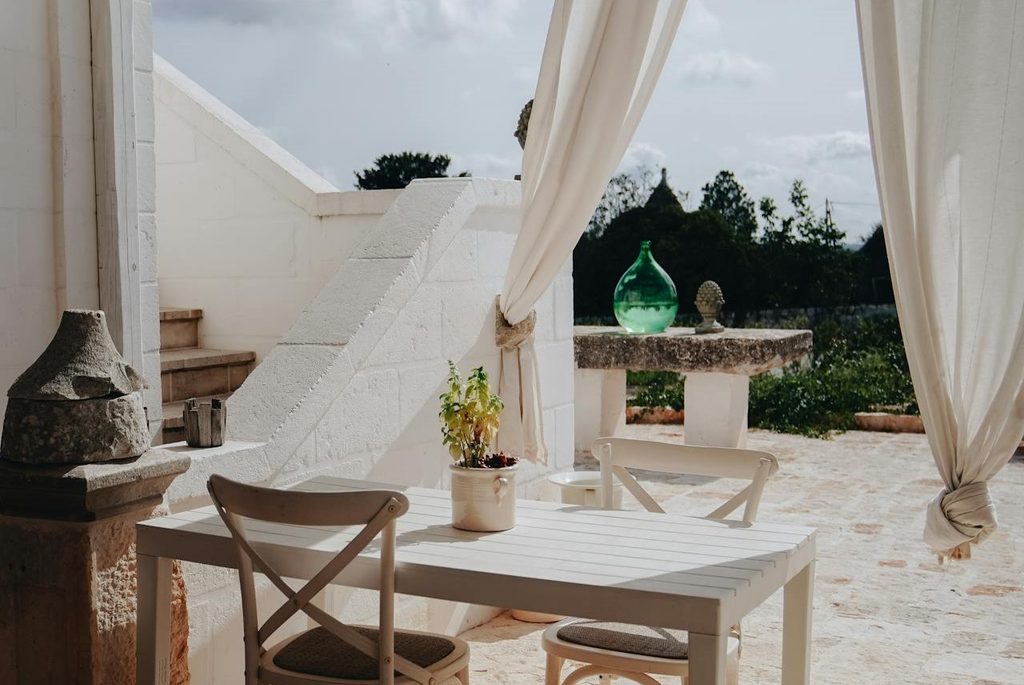 Sheer white curtains on a rustic patio