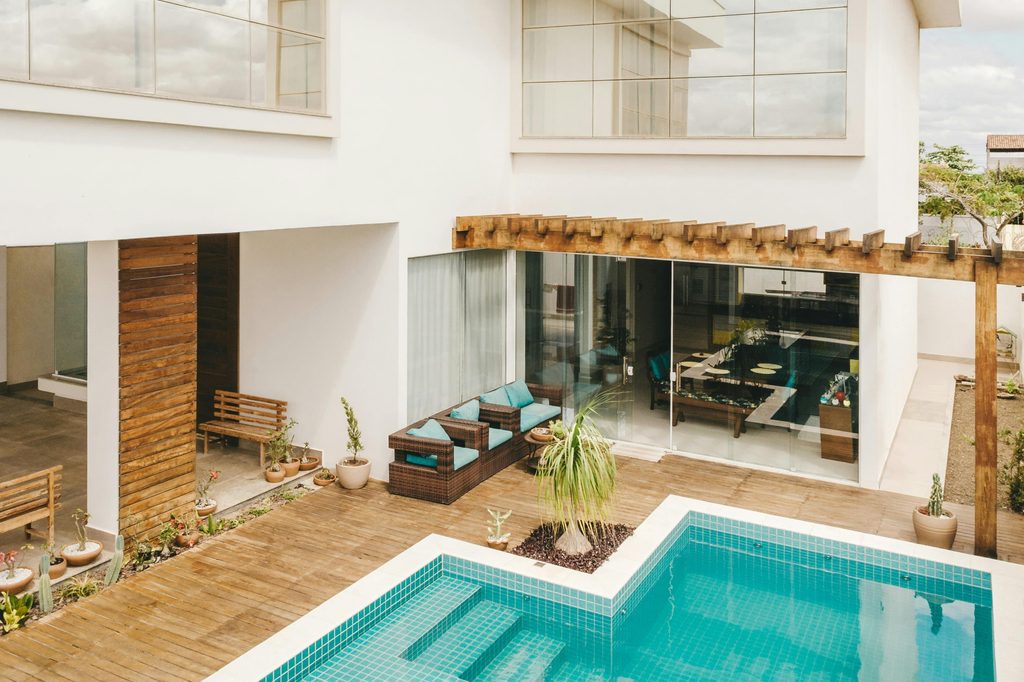 indoor outdoor Mediterranean space with pool and patio