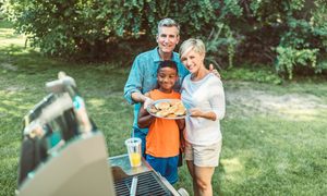 Family grilling out in the backyard
