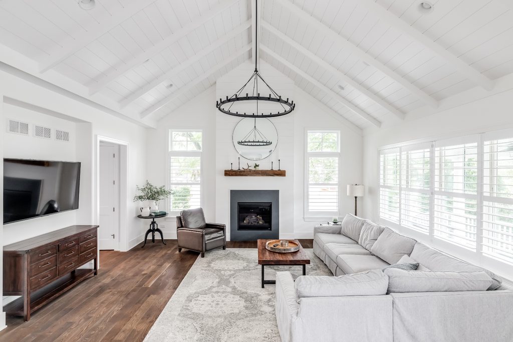 All-white modern farmhouse living room with a beadboard ceiling