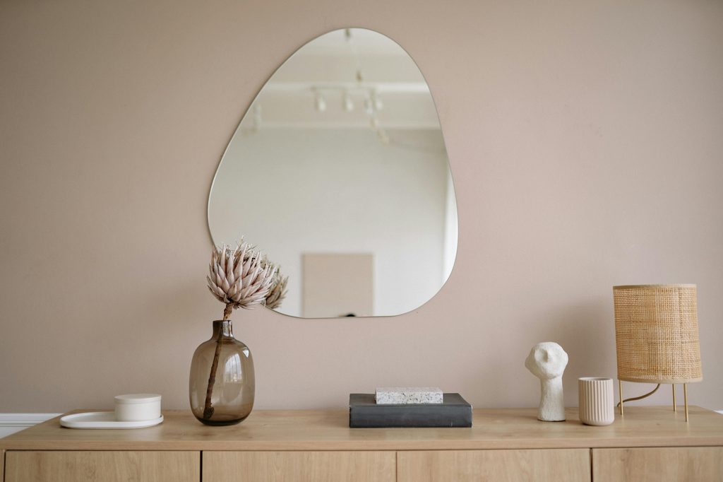 taupe walls in entryway with mirror and table