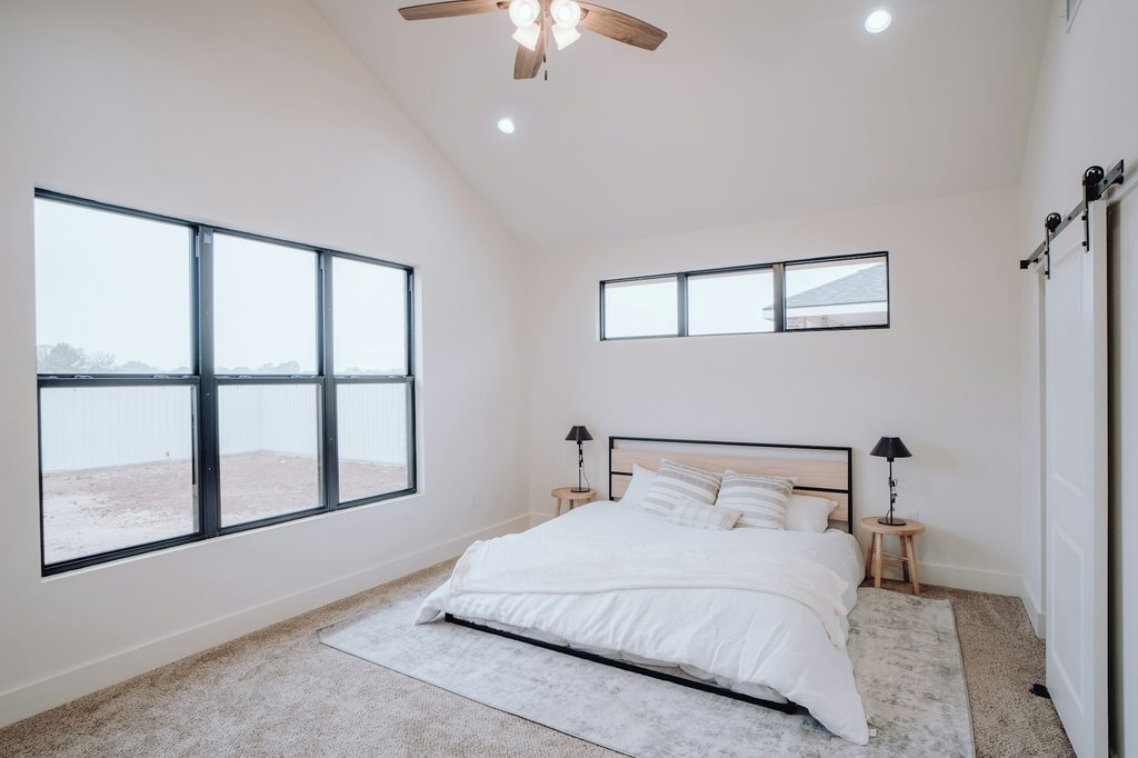 White bedroom with a vaulted ceiling