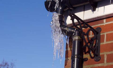 Frozen gutters on outside of brick house