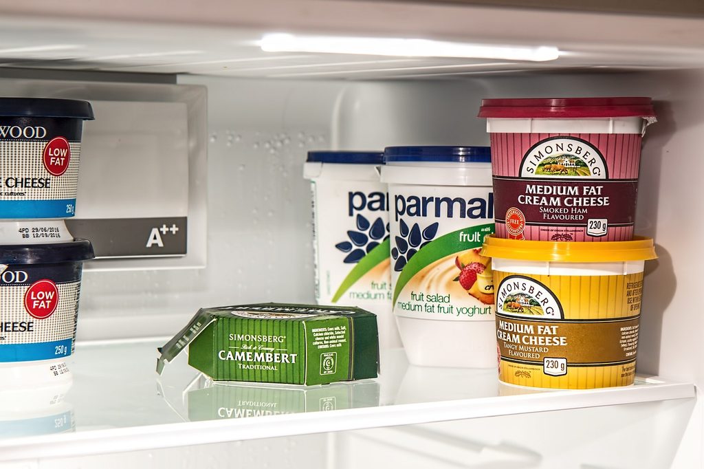 Yogurt and other items on fridge shelf