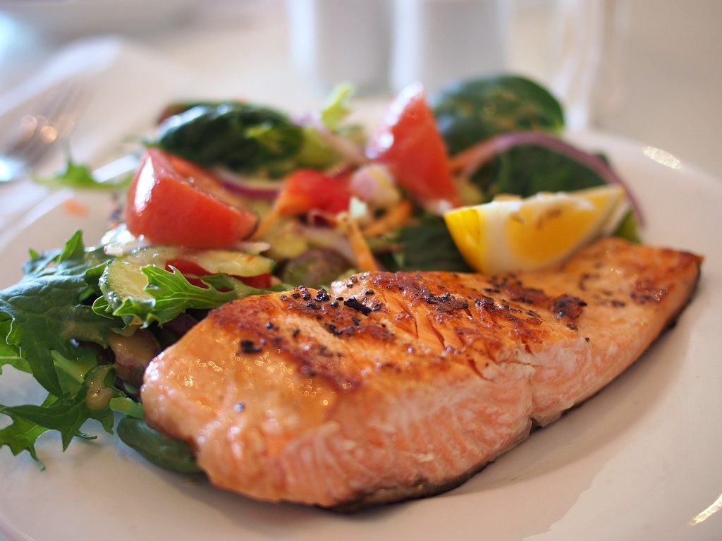 Salmon and veggies on a white plate