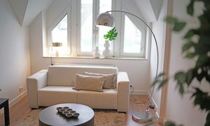 Small living room with light colored walls and furniture. How to make small spaces look bigger.