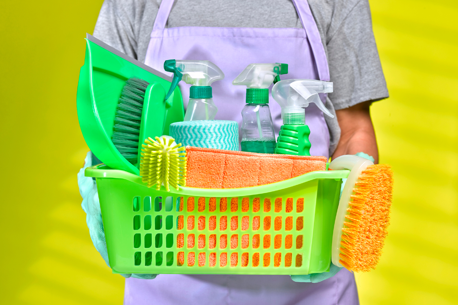 Person holding cleaning supplies