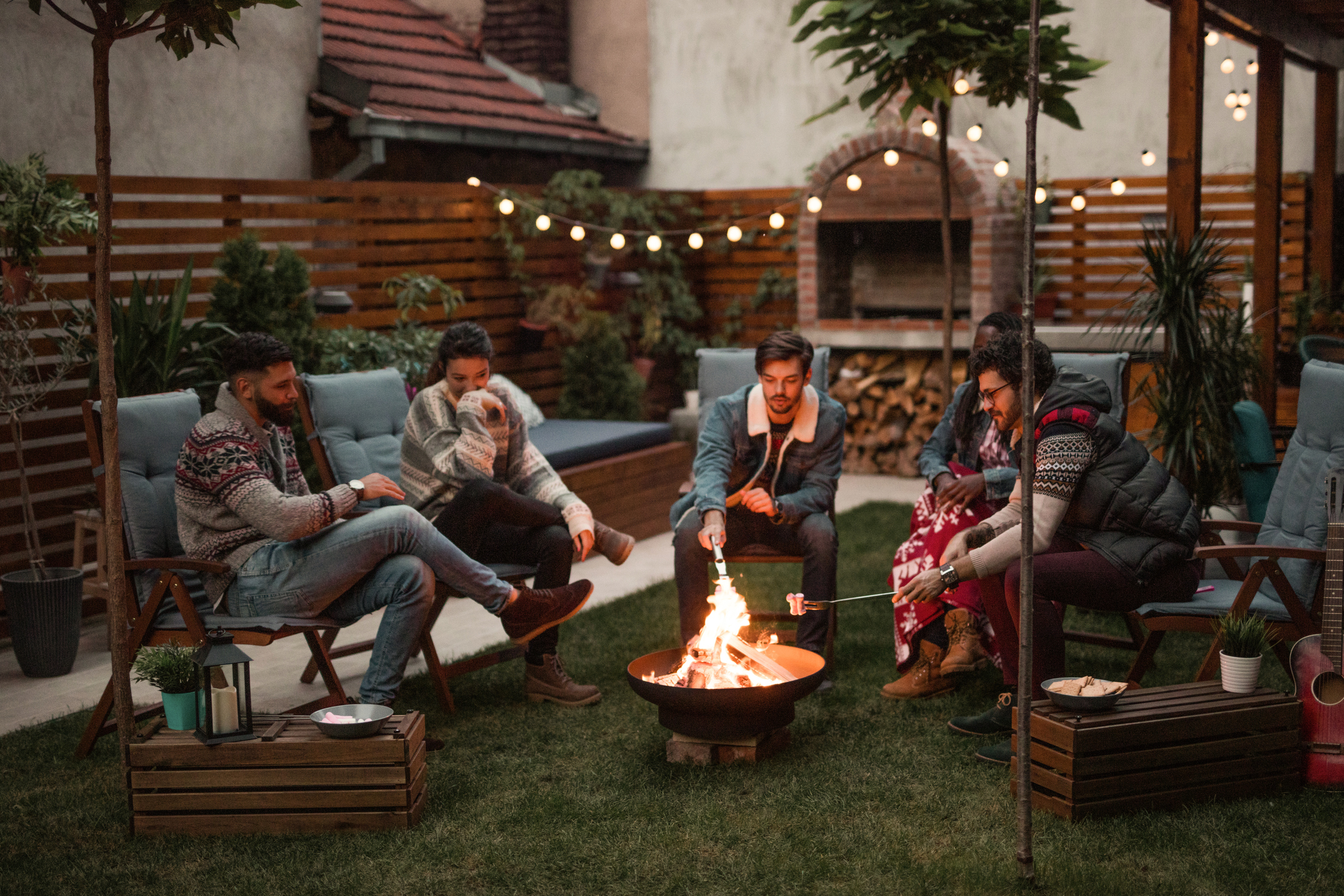 people in outdoor patio with fire pit
