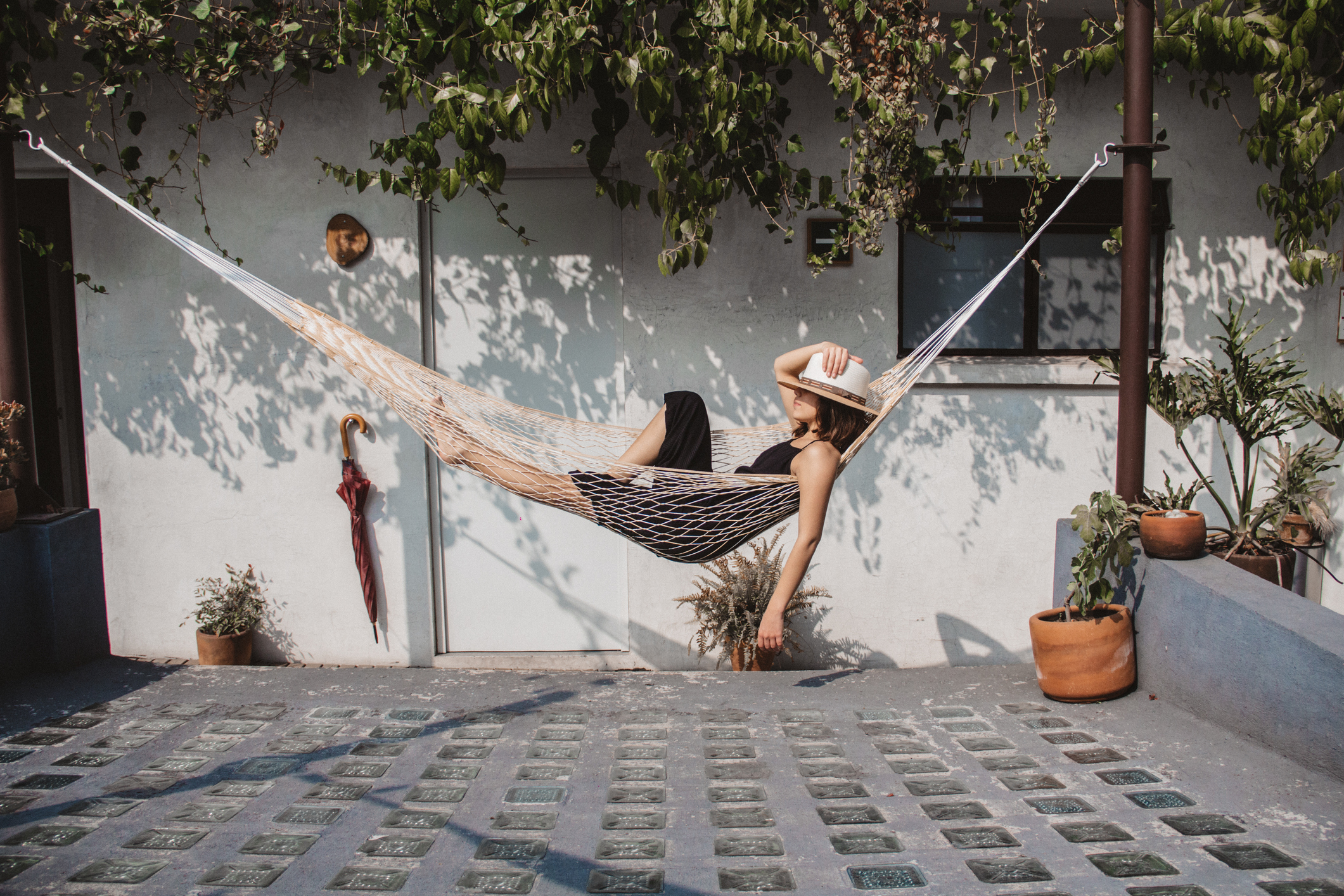 Woman swinging in a hammock on a patio