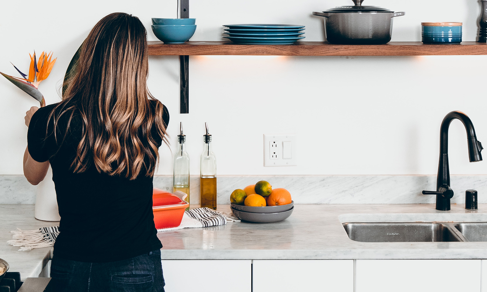 Women Placing Flowers on Kitchen Countertop