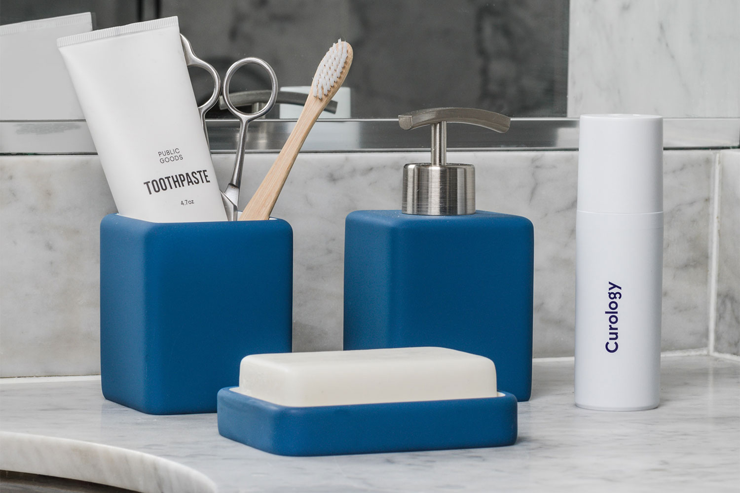 A clean bathroom sink with stored items