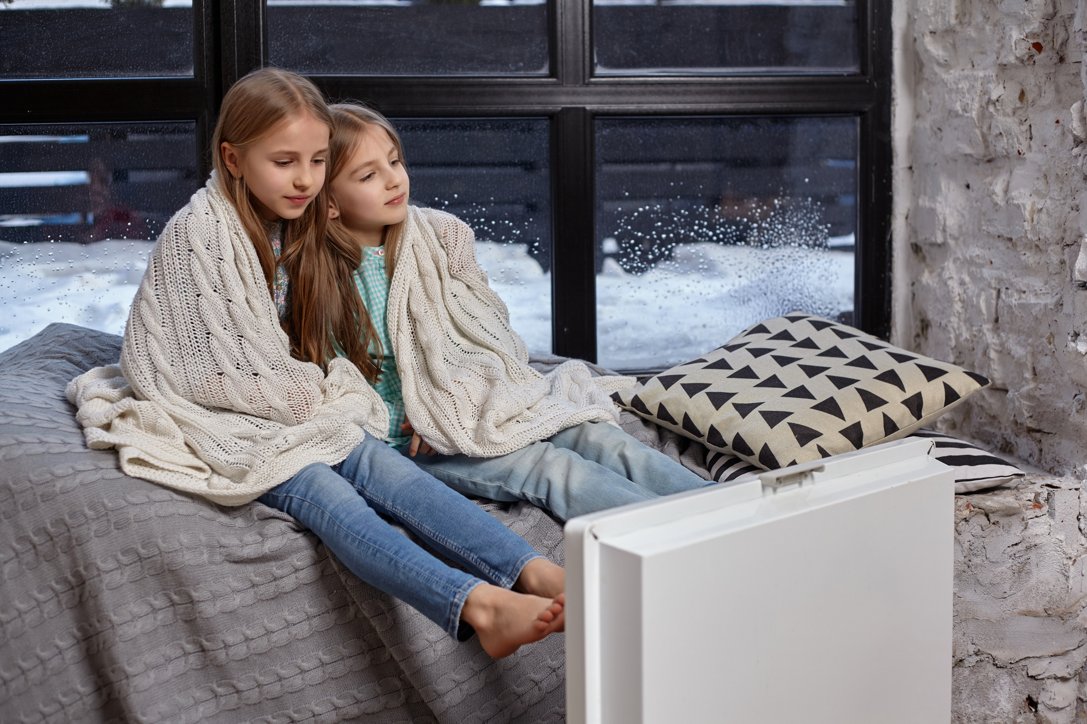 two children wrapped in blankets