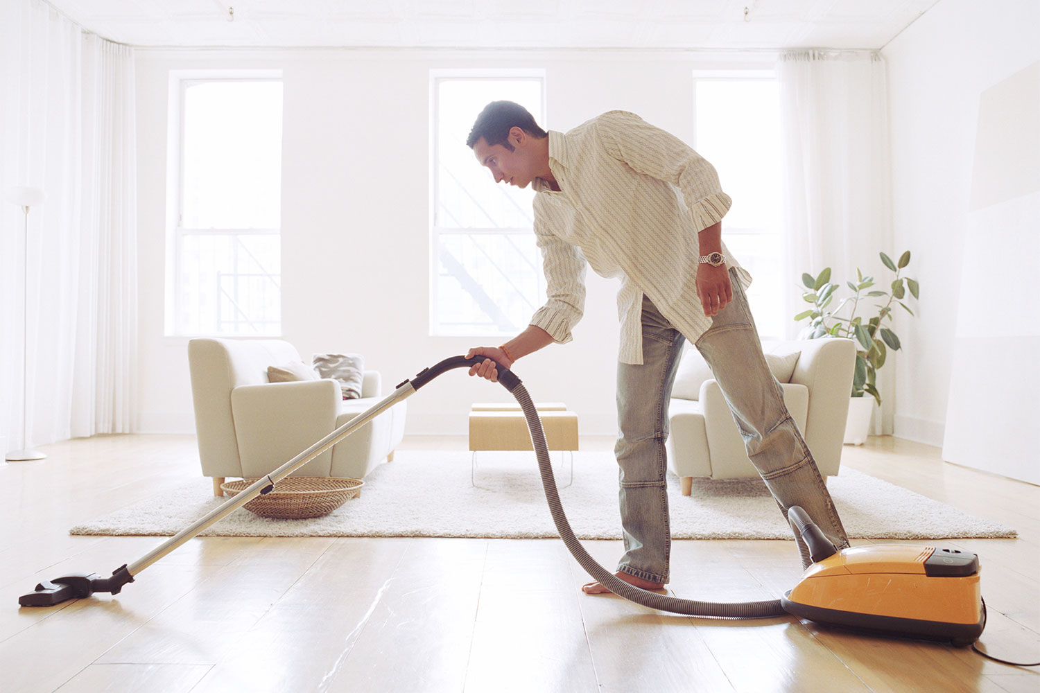 man cleaning living room