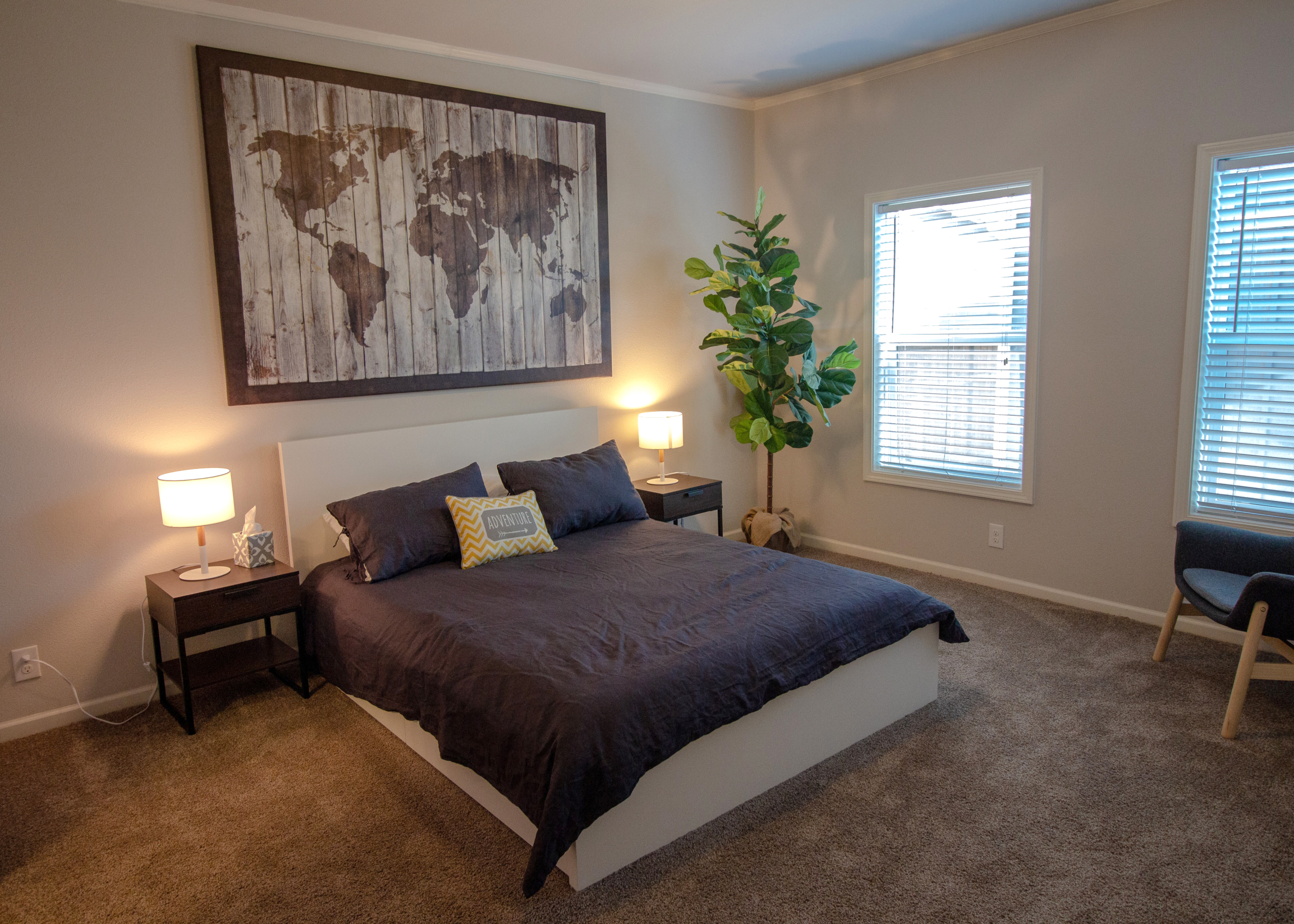 World map wall art above bed