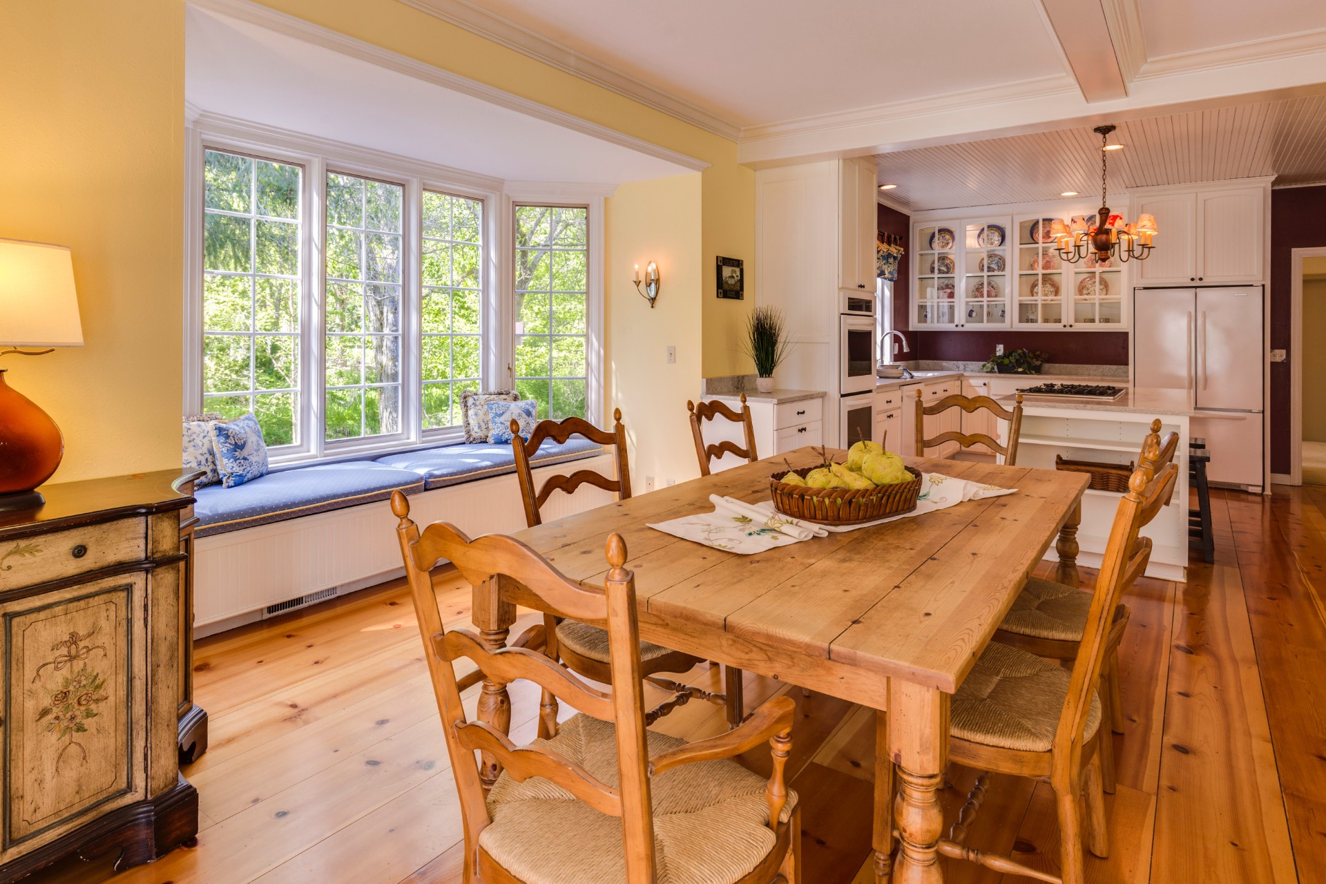 Sunny Country Kitchen with Wooden Table, Chairs, and Floor