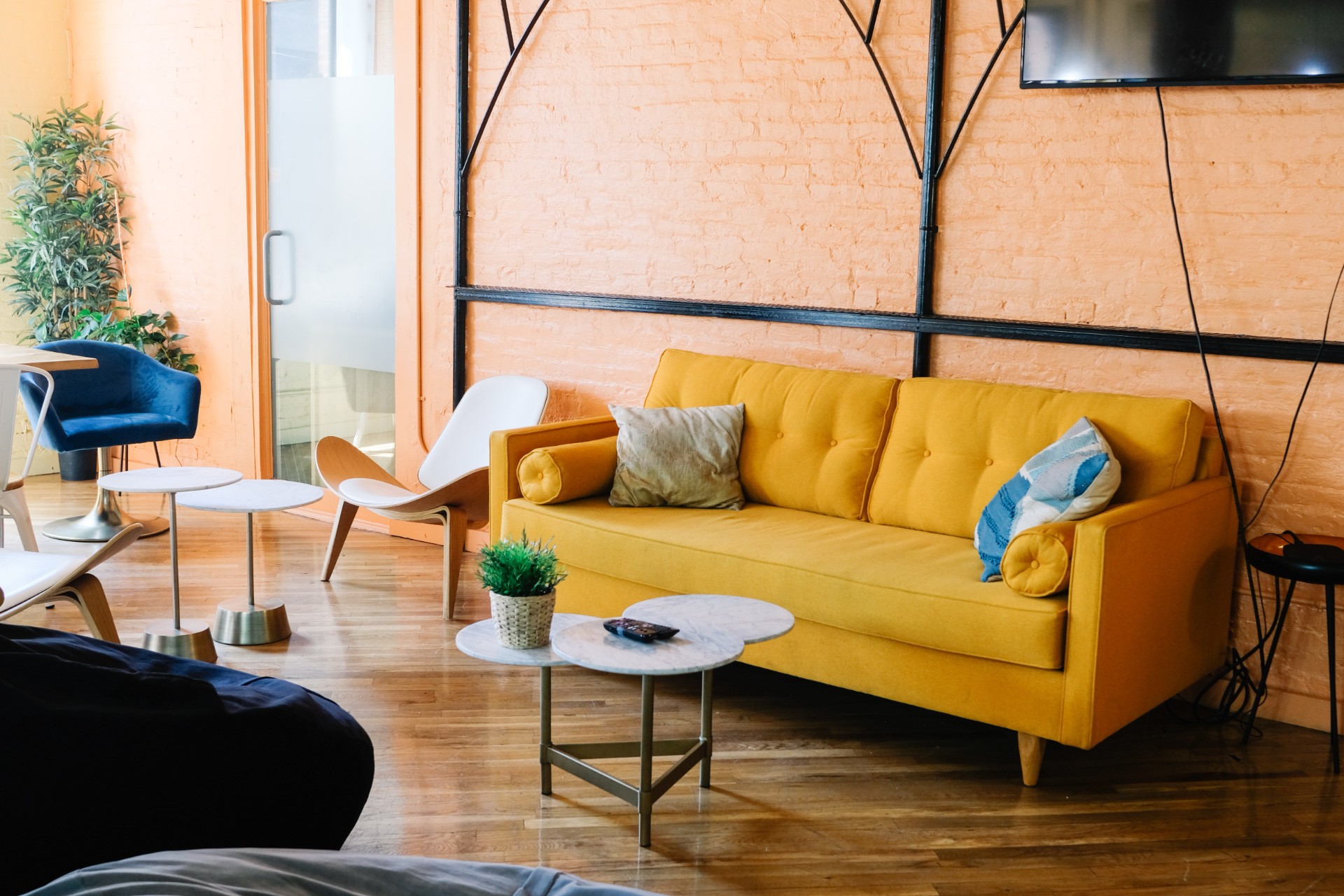 Living room with orange wall and yellow sofa