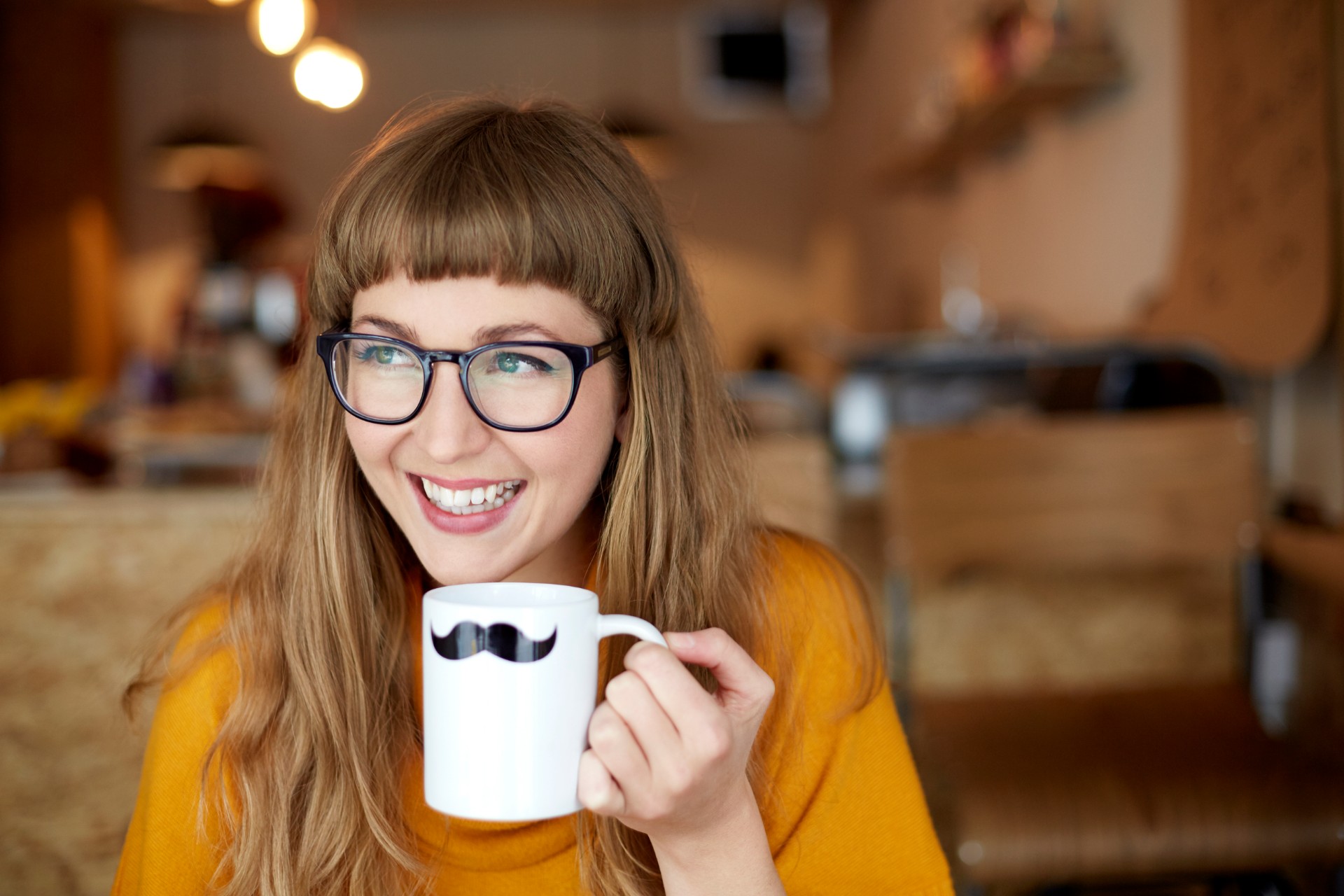 Smiling woman holding novelty mug