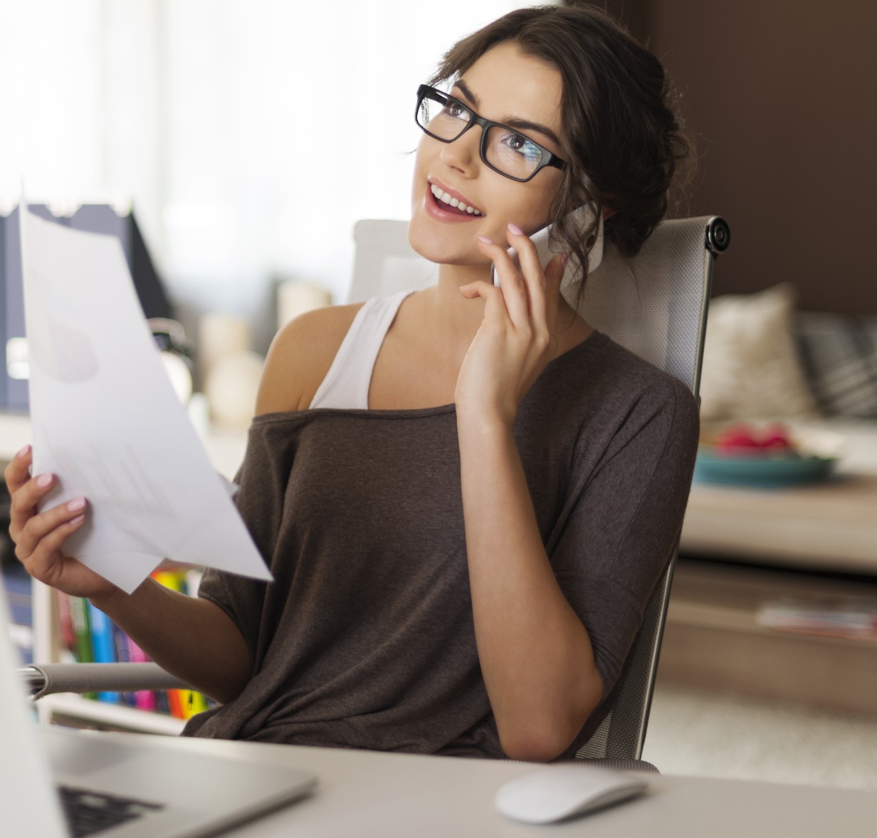 Woman holding papera at desk