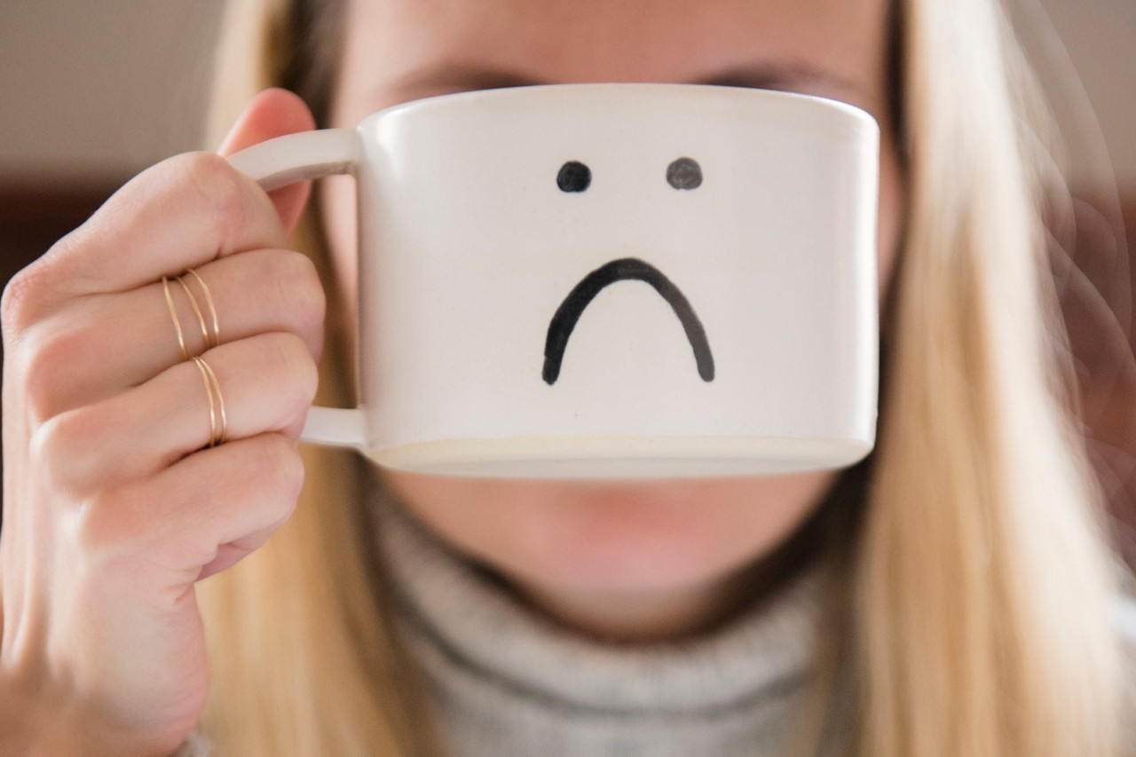 Woman holding novelty coffee mug