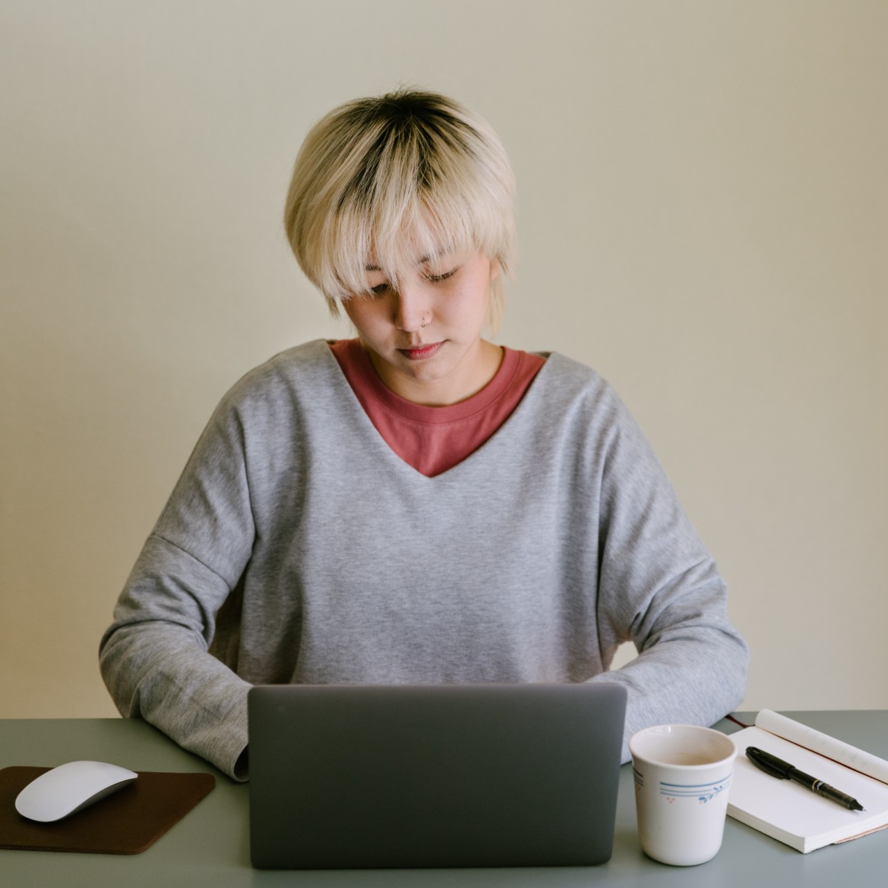Blond woman at desk with laptop