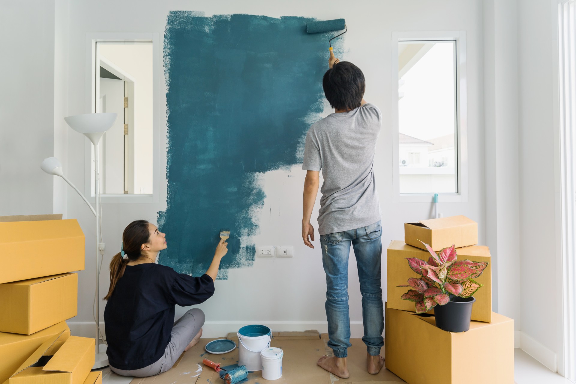 Wife and husband painting a wall