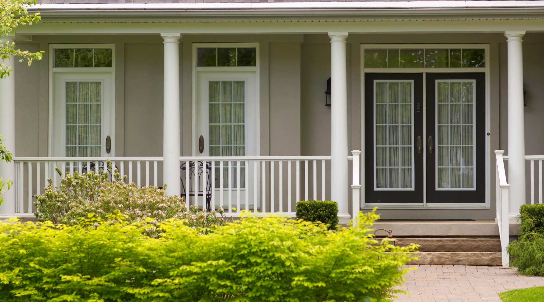 Home with porch and bushes