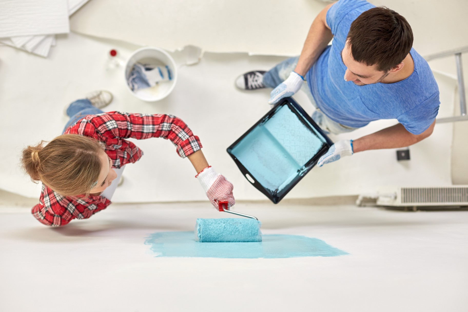 Woman and man painting a wall