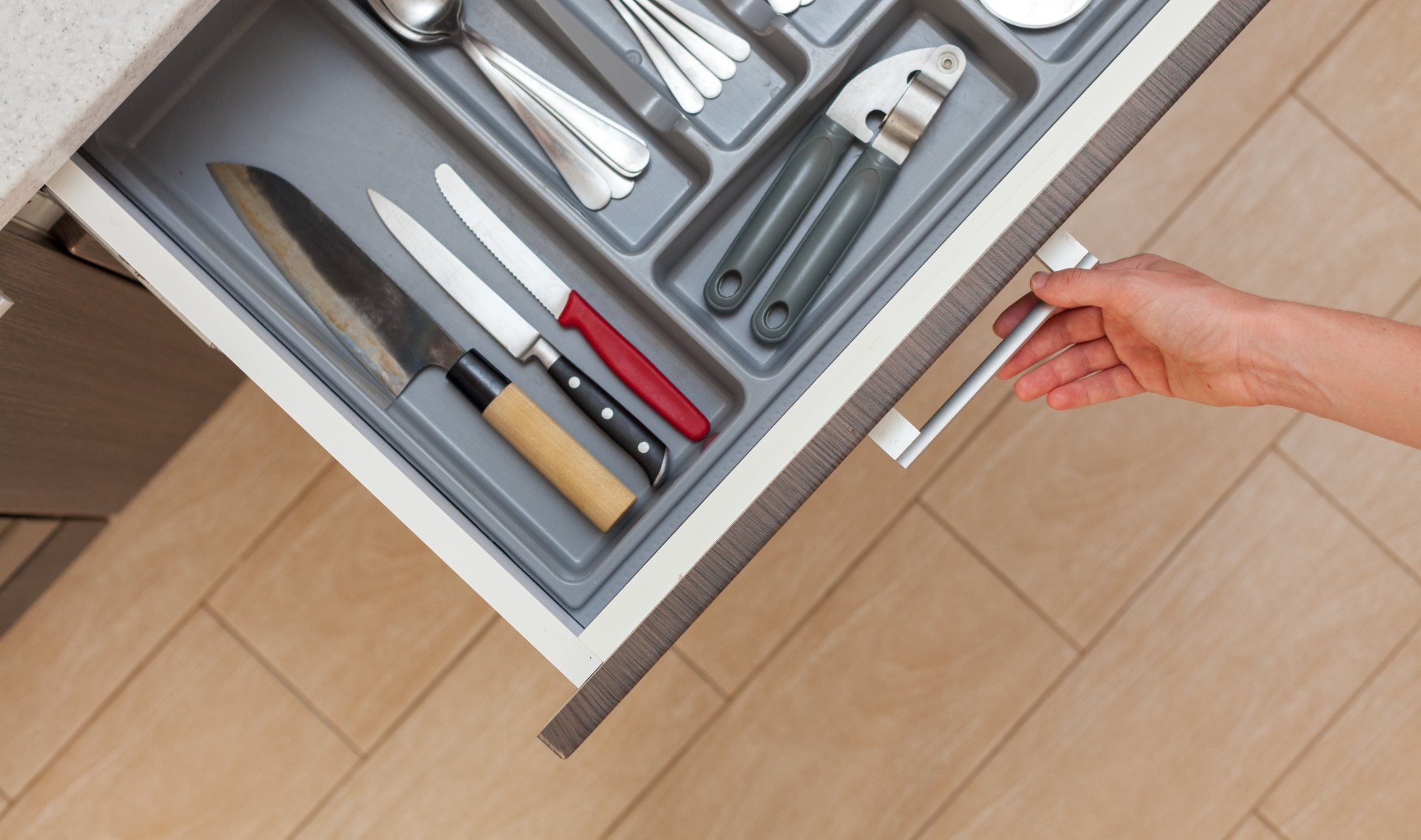 organized kitchen drawer with knives