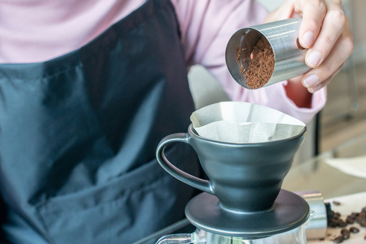 person preparing pour over coffee