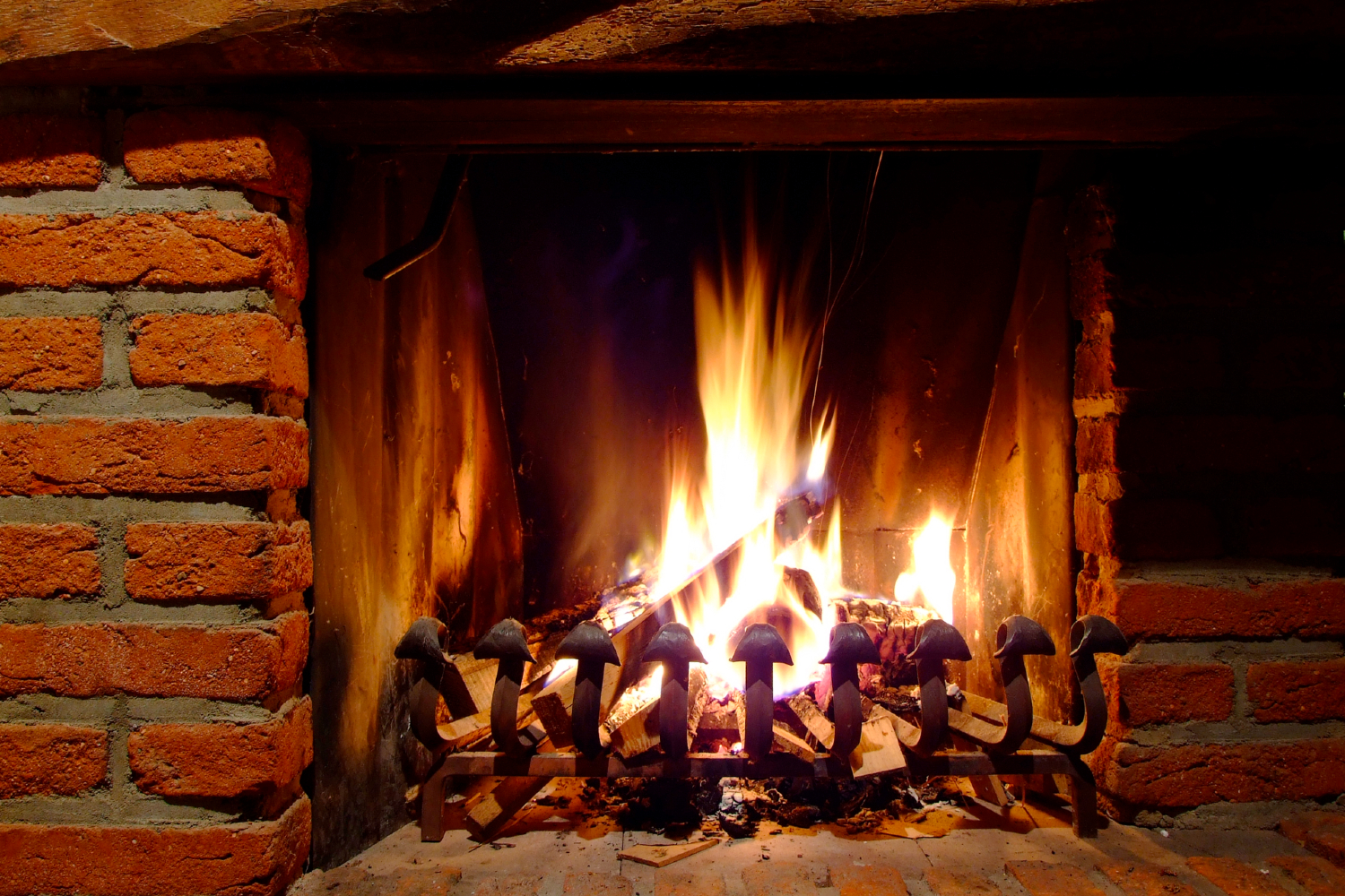 brick fireplace with fire burning