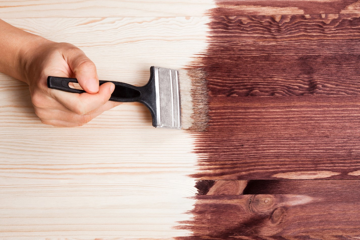 Wooden table being painted brown