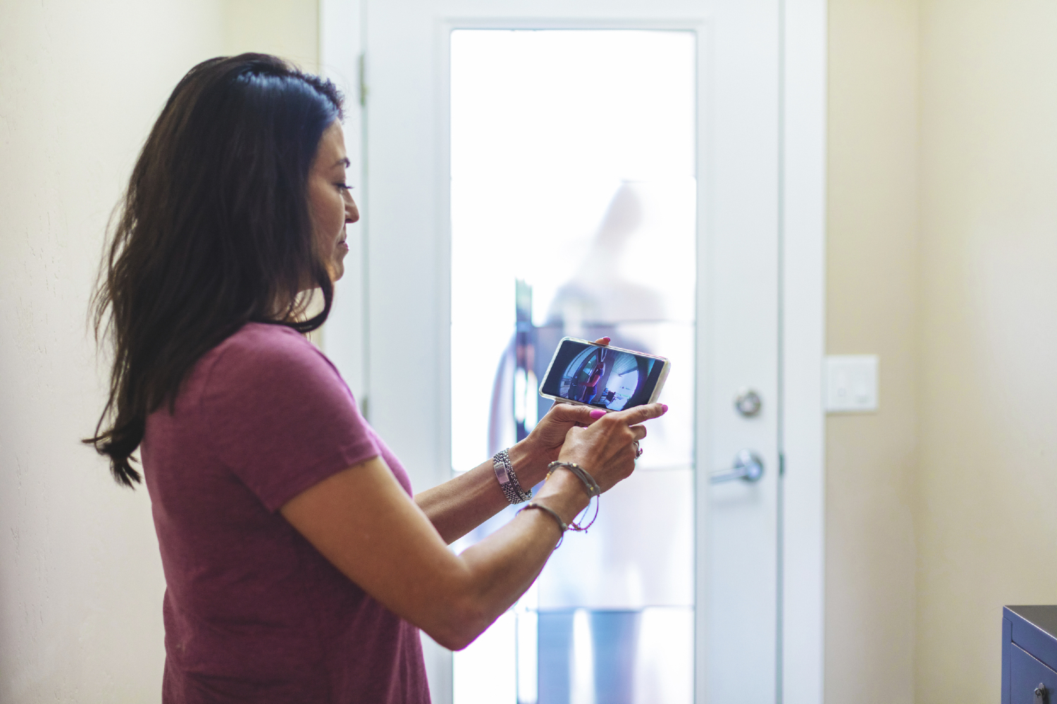 woman using smart doorbell