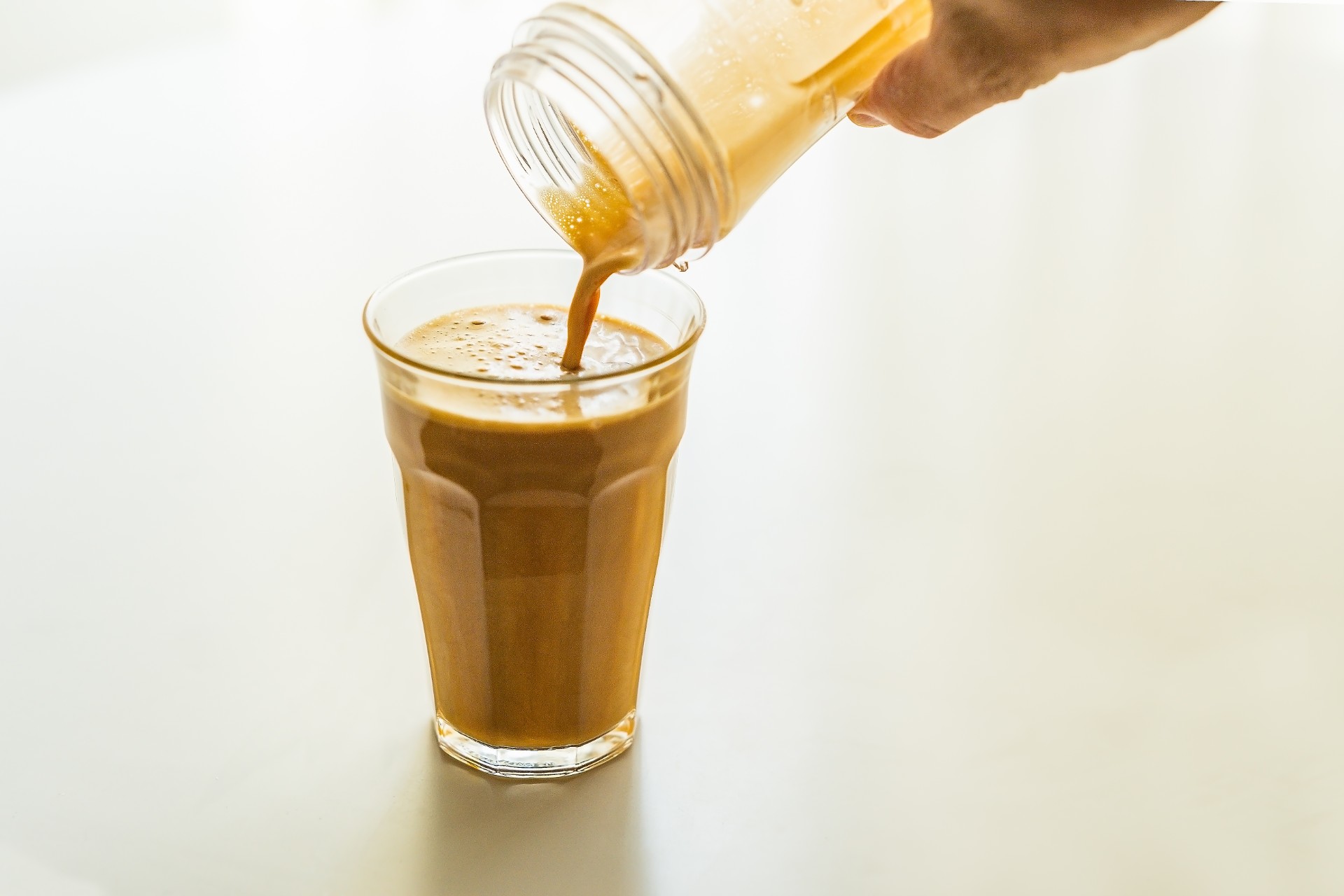 Bulletproof coffee poured into a glass mug