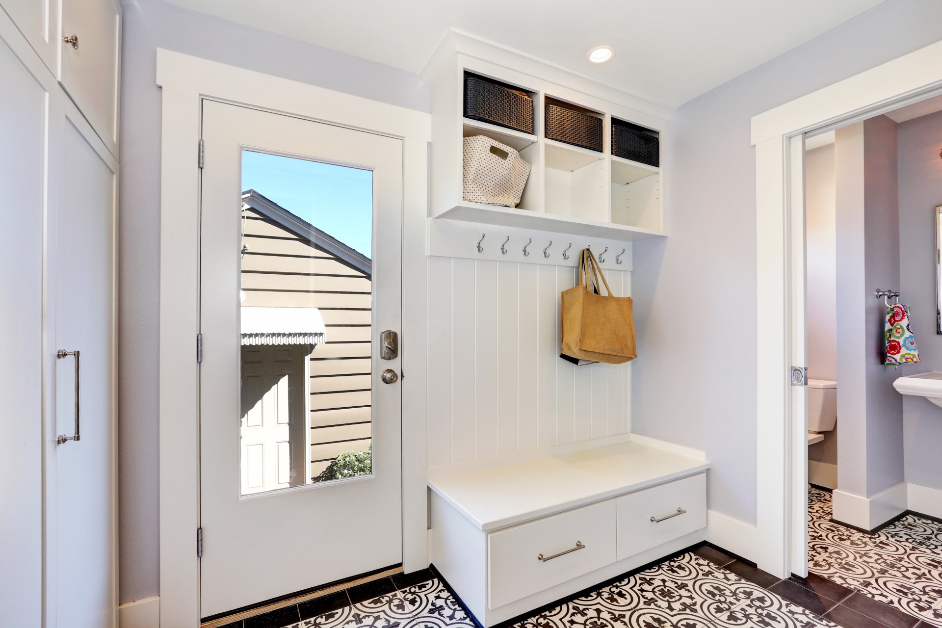 Storage bench with cubby holes in foyer of home