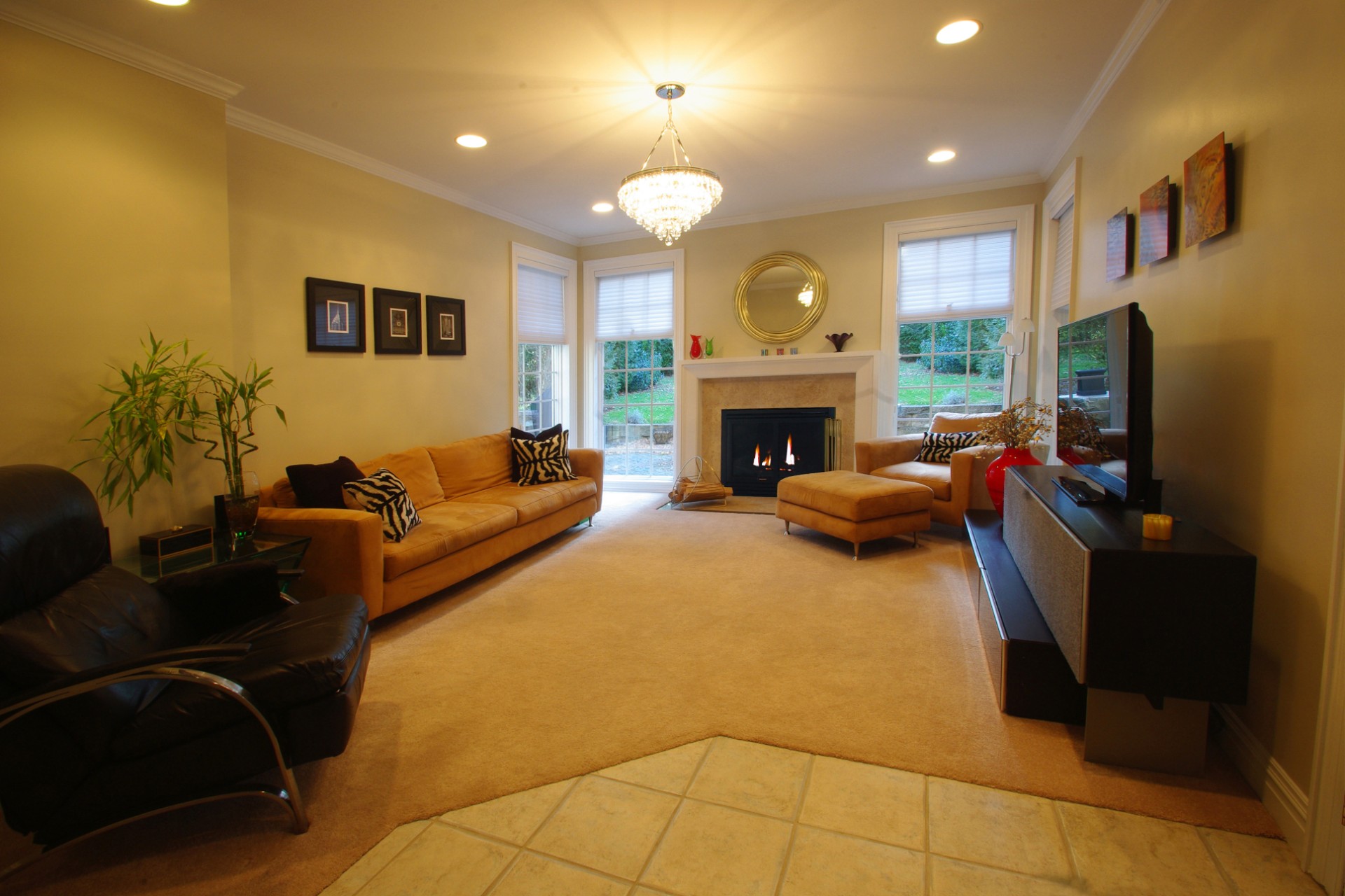 Living room with fancy furniture, fireplace, and crown molding