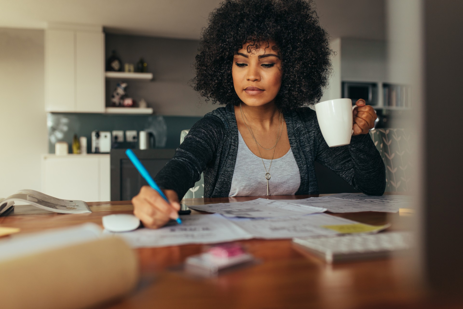 Woman working at desk of her home office