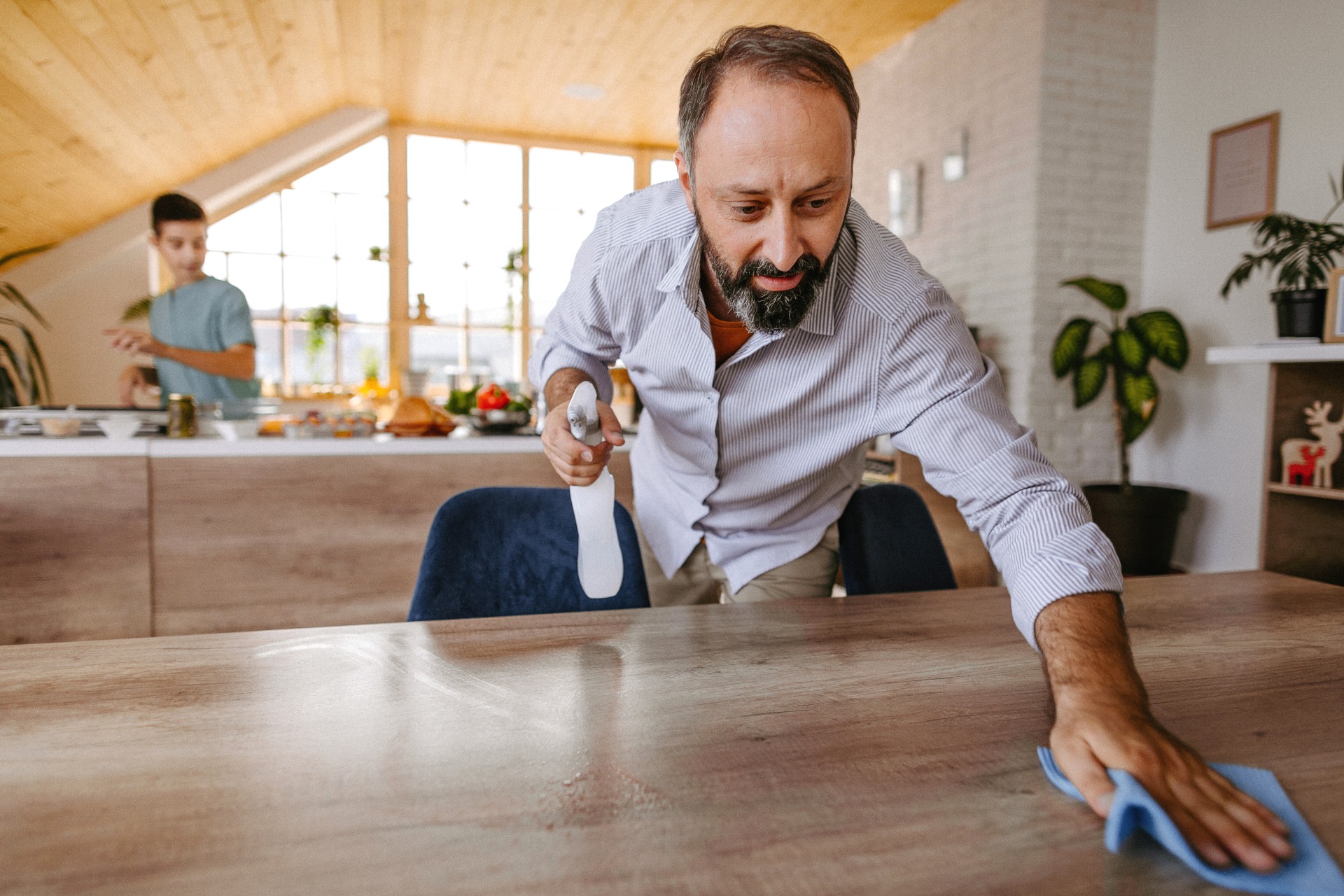 Man cleaning home with a spray bottle