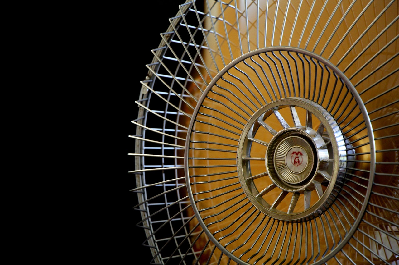 Yellow electric fan with black background