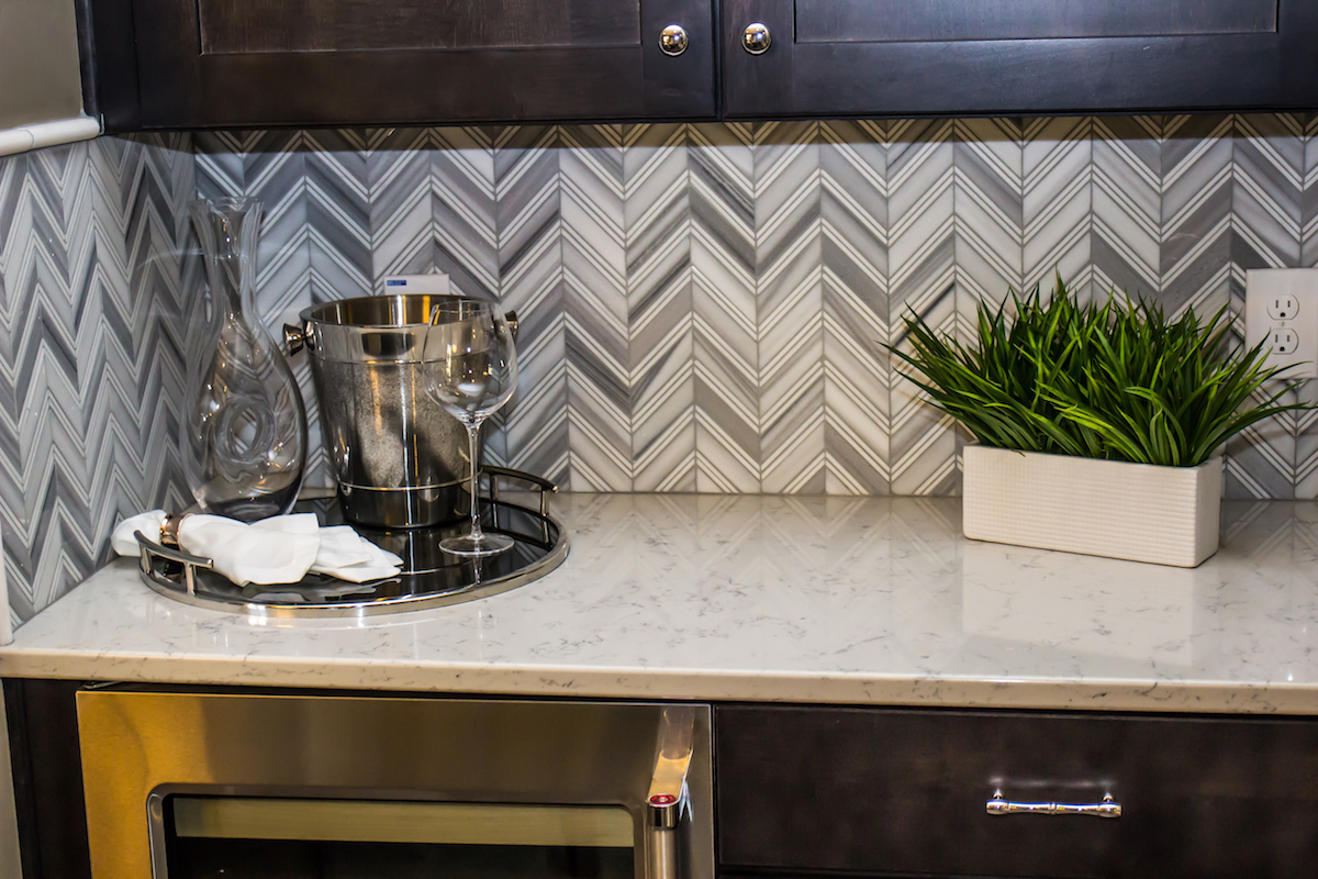 Kitchen counter with gray herringbone backsplash