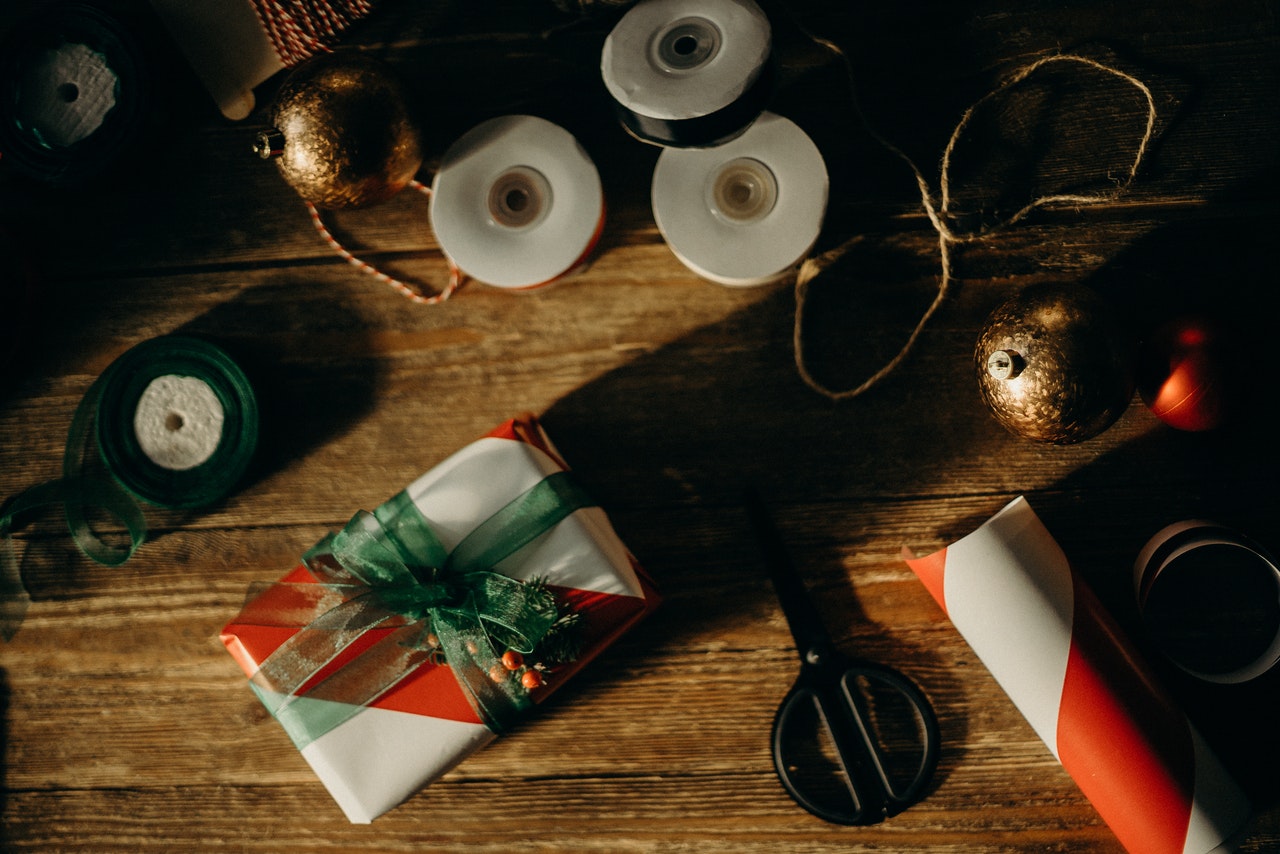 Holiday wrapping materials on wooden table top