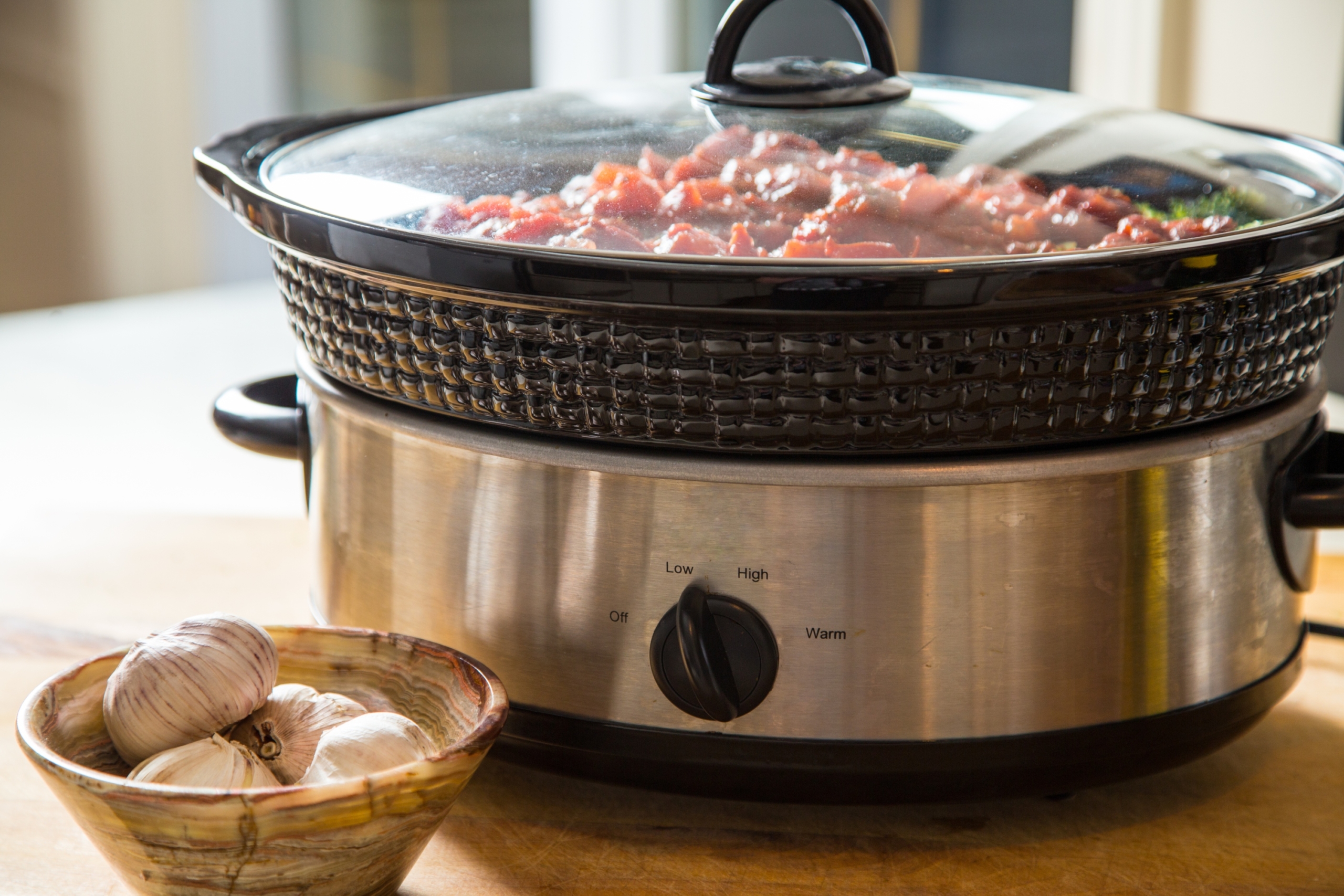 Slow cooker on table with food