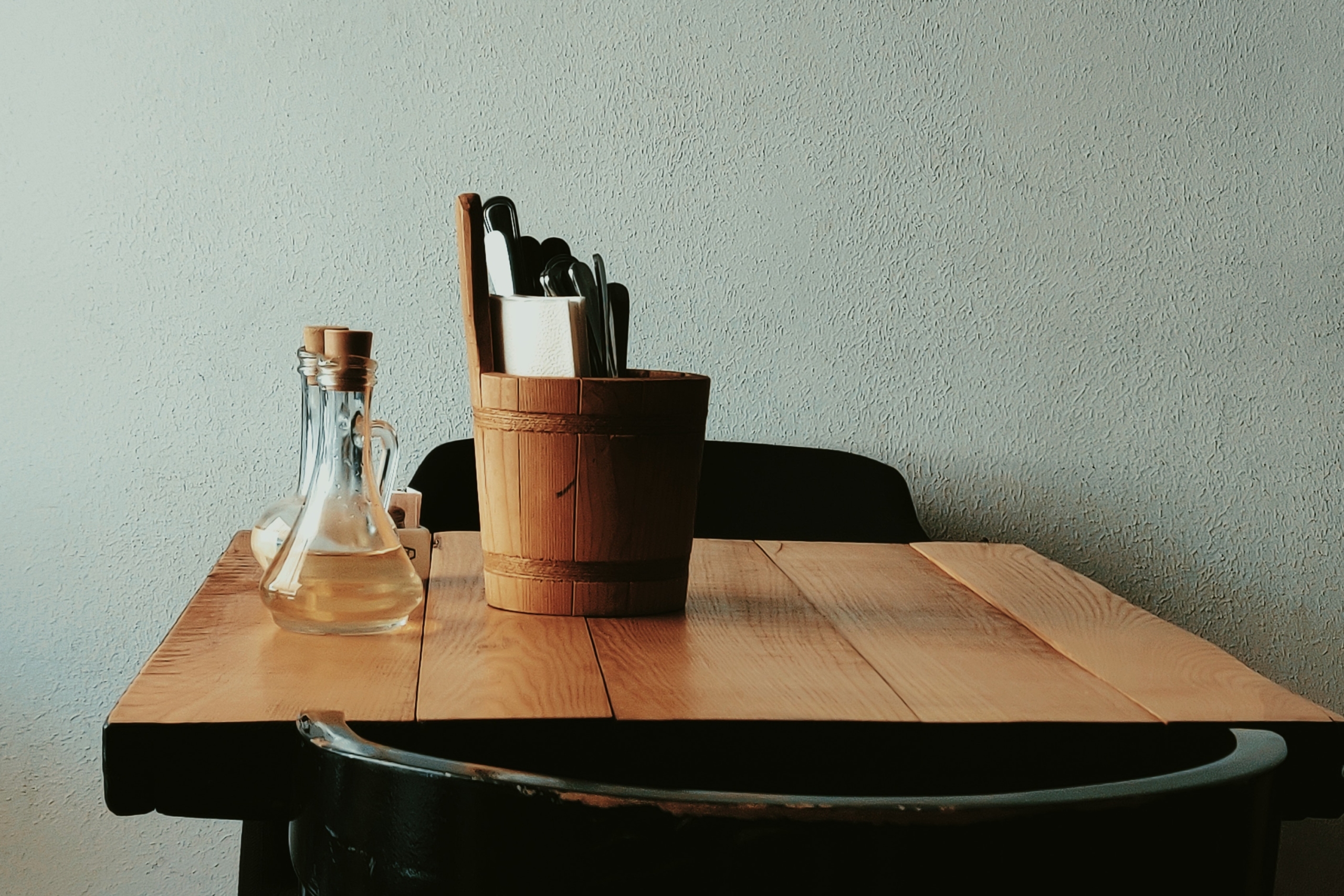 A utensil holder bucket on table