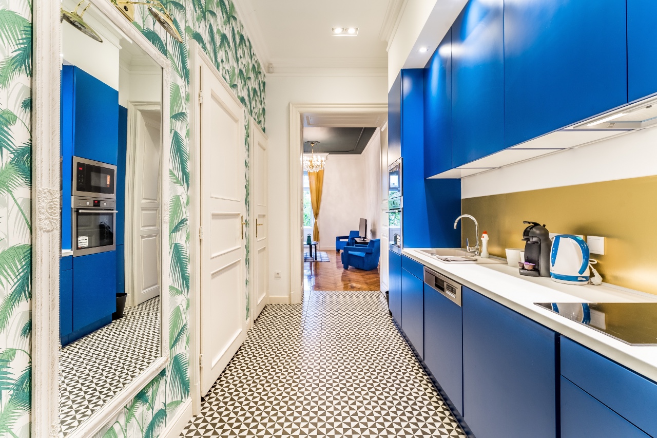 A galley kitchen with blue cabinets